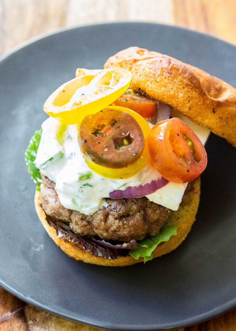 BBQ Meat Ideas: Overhead view of a Greek Lamb Burger on a blue plate.