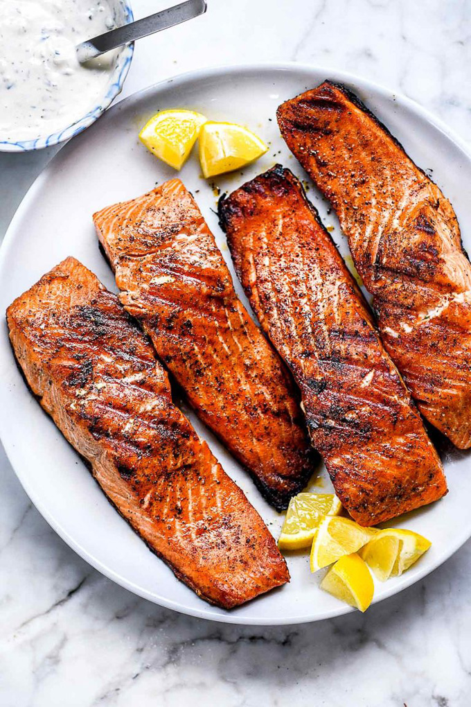 Healthy Grilled Meat Recipes for Summer: Overhead view of Grilled Salmon on a white plate.